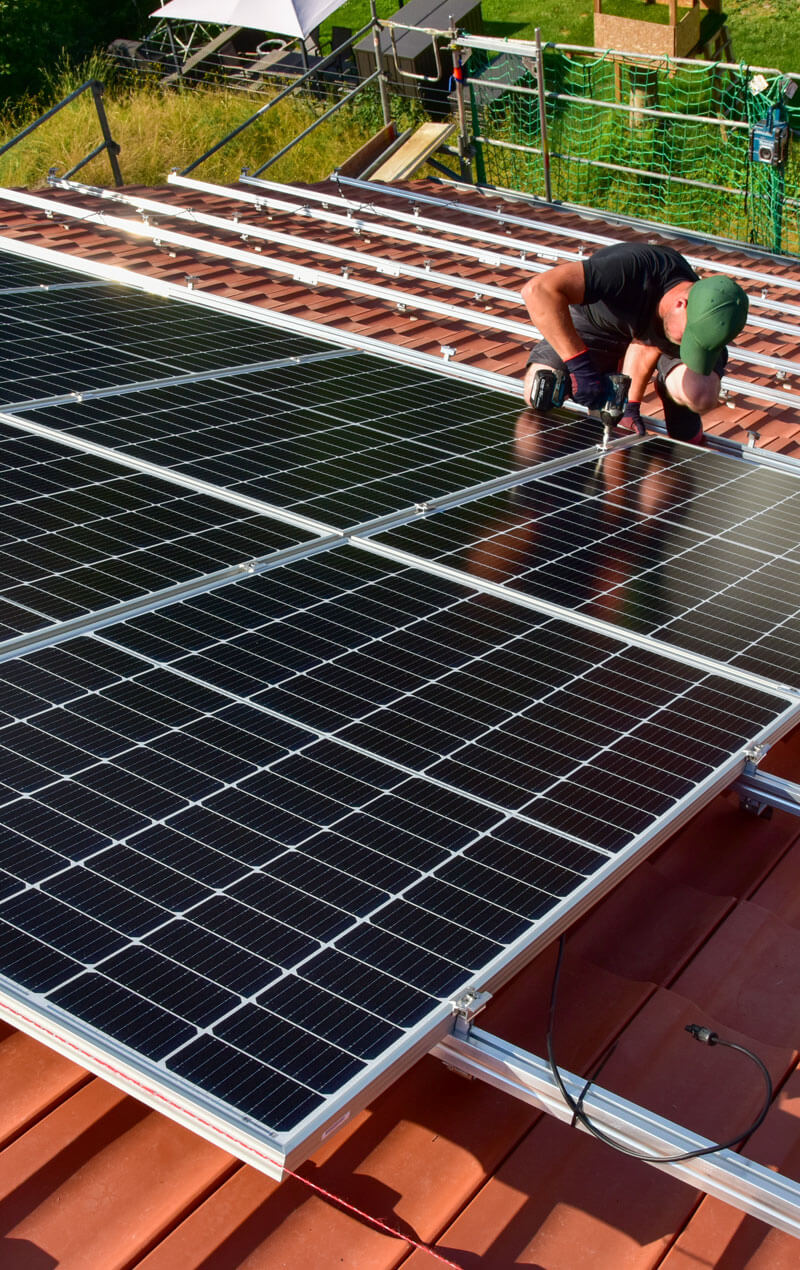 Mitarbeiter auf dem Dach die Solaranlagen einbauen